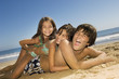 Children in swimwear playing on beach