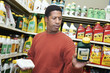 Man selecting plant care products in shop