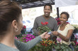 Couple purchasing plants in shop
