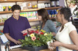 Friends purchasing plants in shop