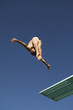 Male diver diving from board, mid air