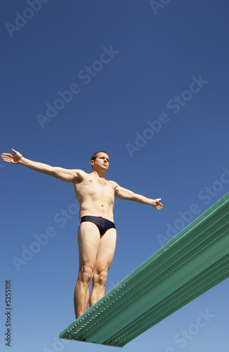 Photo: Man about to dive backwards off a diving board Man about to dive backwards off a diving board