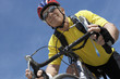 Foto: Man on bicycle ride, portrait, low angle view Man on bicycle ride, portrait, low angle view