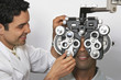 Optician performing eye test on patient