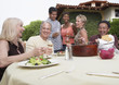Photo: friends eating and drinking in garden friends eating and drinking in garden