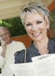 Elegant mature woman holding brochure