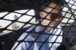 Arrested man sitting in back of police car