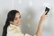 Woman speckling interior wall, elevated view