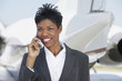 Businesswoman Beside an Airplane