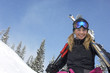 Photo: Teenage girl 16-17 holding skis, in front of snow covered hill Teenage girl 16-17 holding skis, in front of snow covered hill