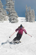 Teenage Girl Skiing Down a Slope