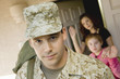 Soldier leaving family outside home