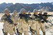 Military soldiers on patrol in mountains