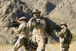 Soldiers carrying rifles in the field