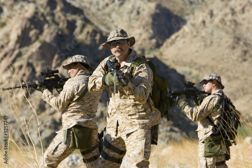 Photo: Soldiers carrying rifles in the field Soldiers carrying rifles in the field