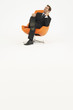 Pensive businessman sitting in chair on white background
