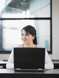 Teenage girl using laptop in classroom