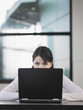 Teenage girl using laptop in classroom