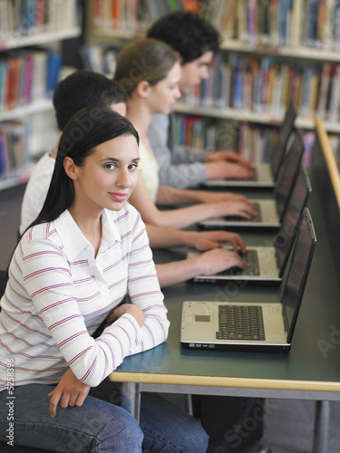 Photo: Students Using Laptops in Library Students Using Laptops in Library