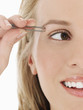 Young Woman Tweezing Eyebrows