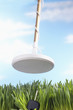 Metal detector finding key in grass