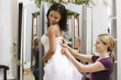 Photo: Seamstress helping bride. Seamstress helping bride.