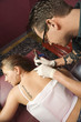 Woman getting tattoo.