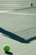 Tennis ball with net shadow and white line..