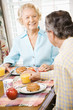 Mature couple eating breakfast.