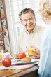 Mature couple eating breakfast.