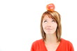 pretty girl with apple on head