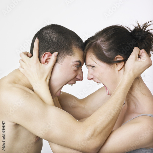 Photo: Couple locked in angry embrace Couple locked in angry embrace
