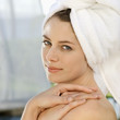 Photo: Woman wearing towel with hands on shoulder. Woman wearing towel with hands on shoulder.