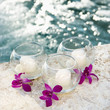 Three candles and three purple orchids by pool. Three candles and three purple orchids by pool.