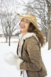 Foto: Female holding snowball and wearing straw cowboy hat. Female holding snowball and wearing straw cowboy hat.
