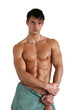 Wet Muscular Man Wrapped in a Towel Isolated on White