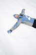 Foto: Woman making snow angel. Woman making snow angel.