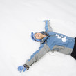 Foto: Woman making snow angel. Woman making snow angel.