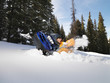Man with stuck snowmobile.