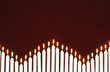 Row of lit candles, on black background
