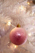 Christmas bauble hanging on tree, close-up