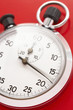 Stopwatch on red background, studio shot