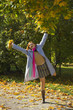 The cheerful beautiful girl in autumn park