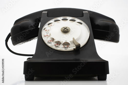 Photo: Old fashioned black telephone in studio Old fashioned black telephone in studio