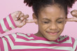 Girl with eyes closed, putting Fingers in Ears, close-up