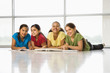 Photo: Preteen girls sitting together on floor with schoolwork. Preteen girls sitting together on floor with schoolwork.