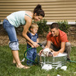 Foto: Family giving dog a bath. Family giving dog a bath.