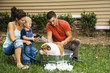Foto: Family giving dog a bath. Family giving dog a bath.