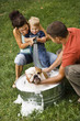 Family giving dog a bath. Family giving dog a bath.