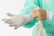 an assistant putting on her gloves before the operation